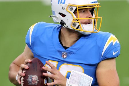 Los Angeles quarterback #10 Justin Herbert looks for a receiver in a 2021 home game.