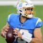 Vikings vs Chargers Predictions: Los Angeles quarterback #10 Justin Herbert looks for a receiver in a 2021 home game.