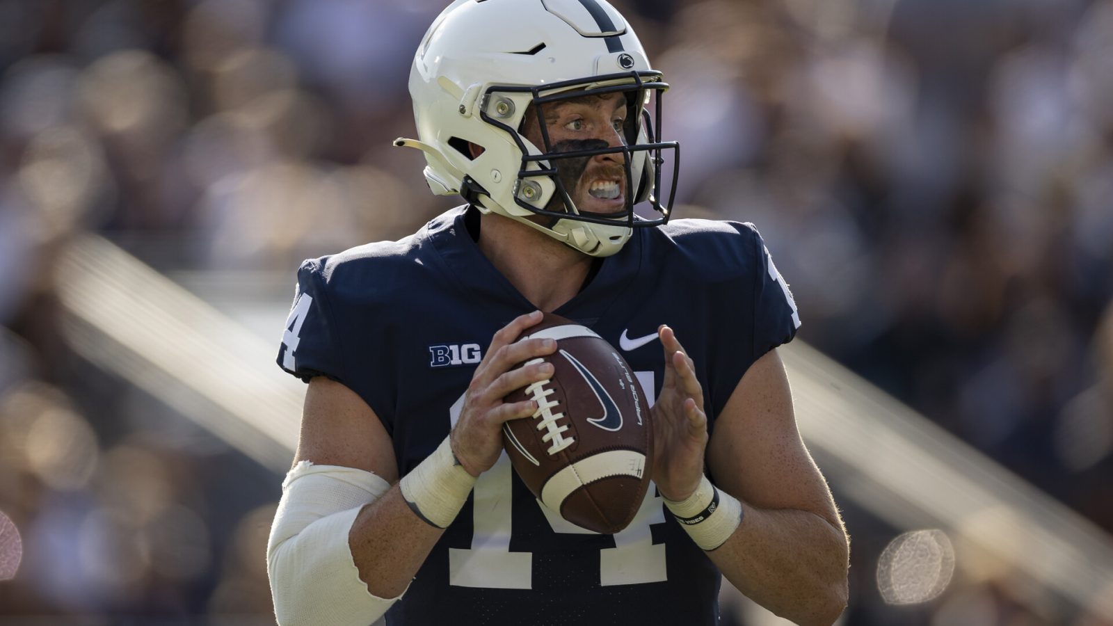 Penn State quarterback Sean Clifford looks downfield for an open receiver while holding the football