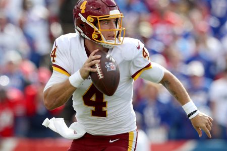 Washington Football Team quarterback #4 Taylor Heinicke scrambles out of the pocket against the Bills.