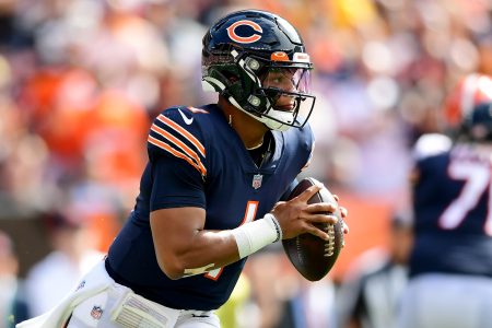 Chicago Bears quarterback #1 Justin Fields looks for a receiver in a 2021 home game.