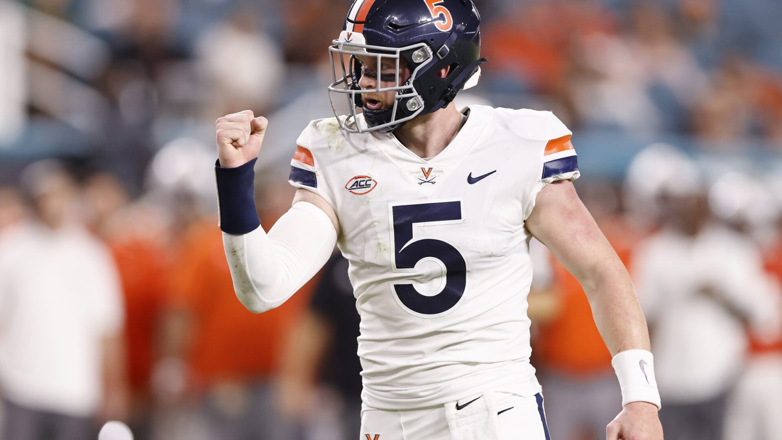 Virginia QB Brennan Armstrong completes a pass in a 2021 road game.