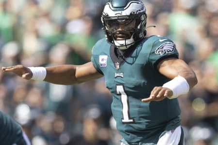 Philadelphia quarterback #1 Jalen Hurts audibles the play at the line of scrimmage in a 2021 home game.