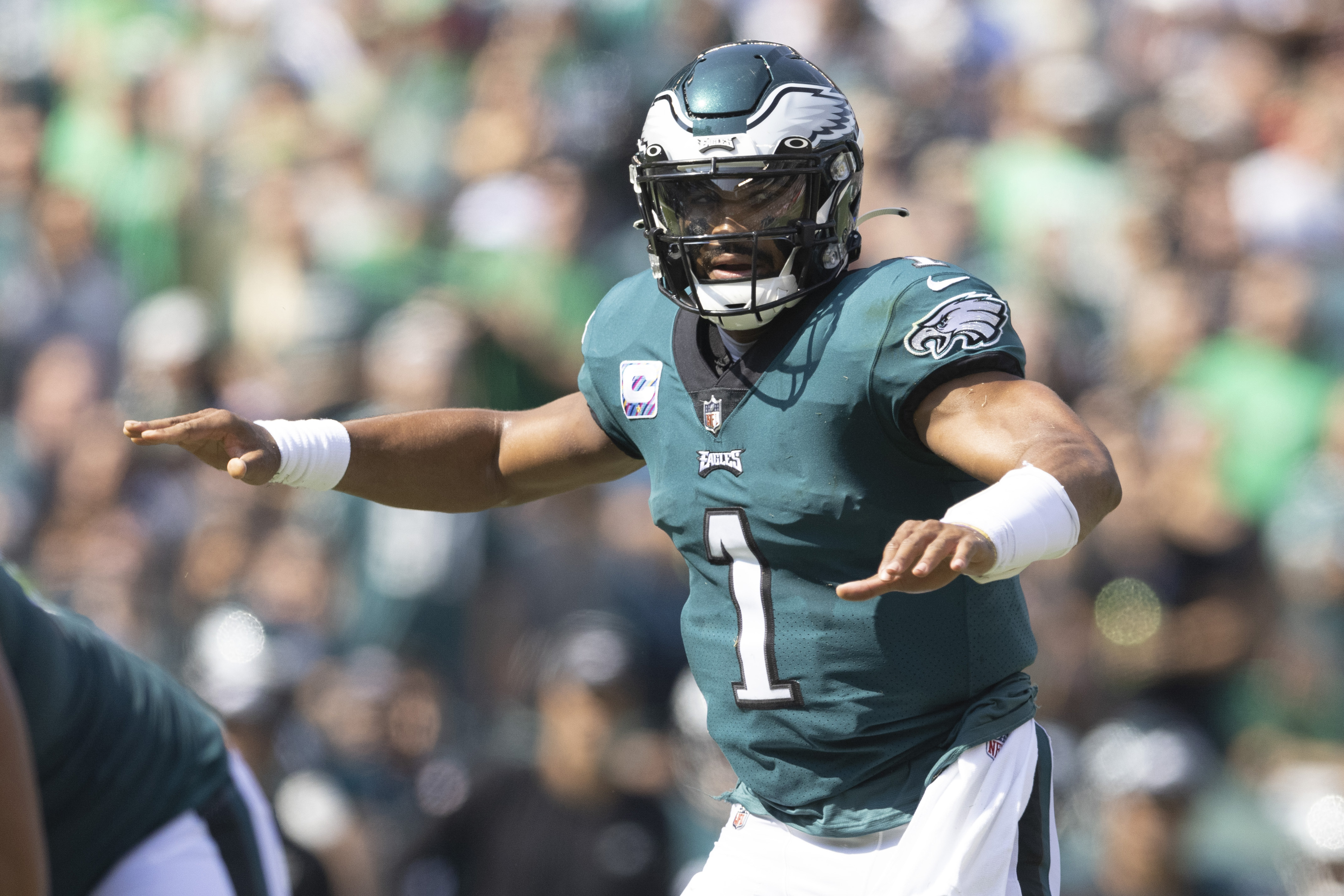Philadelphia quarterback #1 Jalen Hurts audibles the play at the line of scrimmage in a 2021 home game.