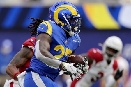 Los Angeles Rams running back #27 Darrell Henderson tries to find running room in a 2021 home game against the Arizona Cardinals.