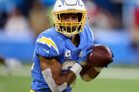 Los Angeles Chargers running back #30 Austin Ekeler looks upfield for running room in a 2021 home game.