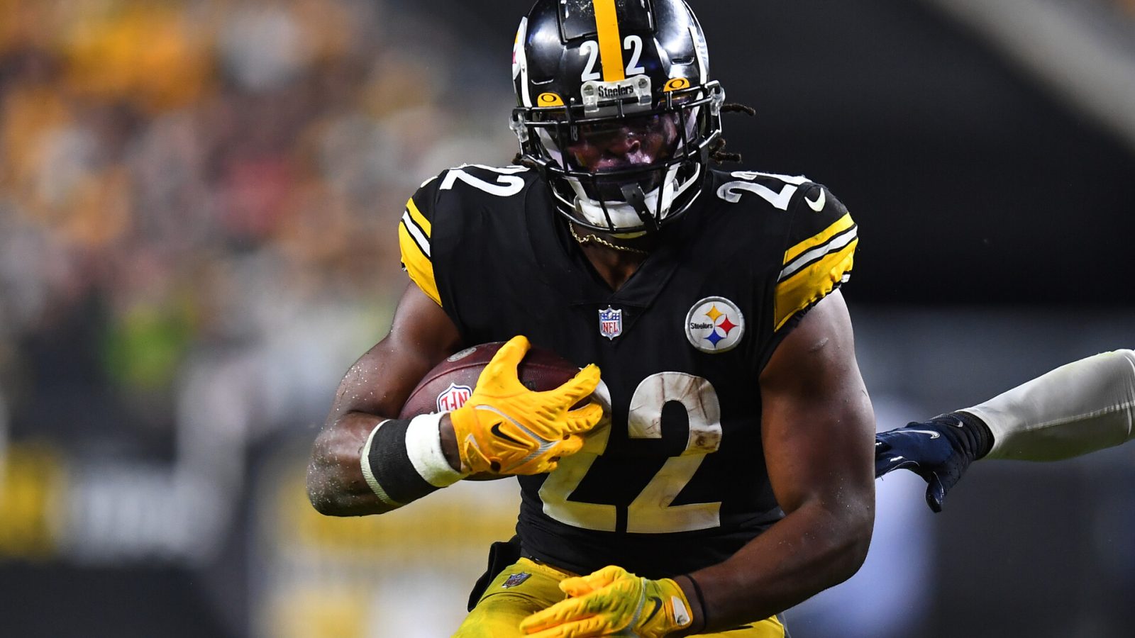 Pittsburgh Steelers running back #22 Najee Harris carries the ball in a 2021 home game.