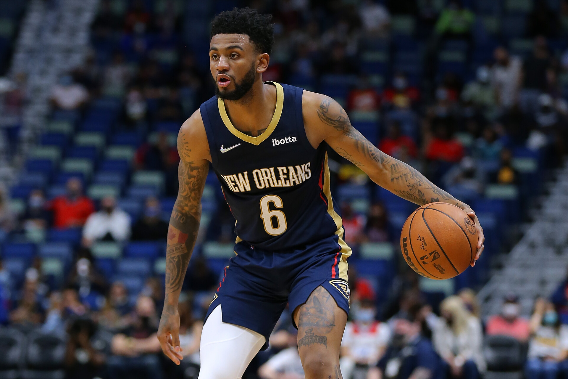 New Orleans Pelicans guard #6 Nickeil Alexander-Walker dribbles the ball in a 2021 home game.
