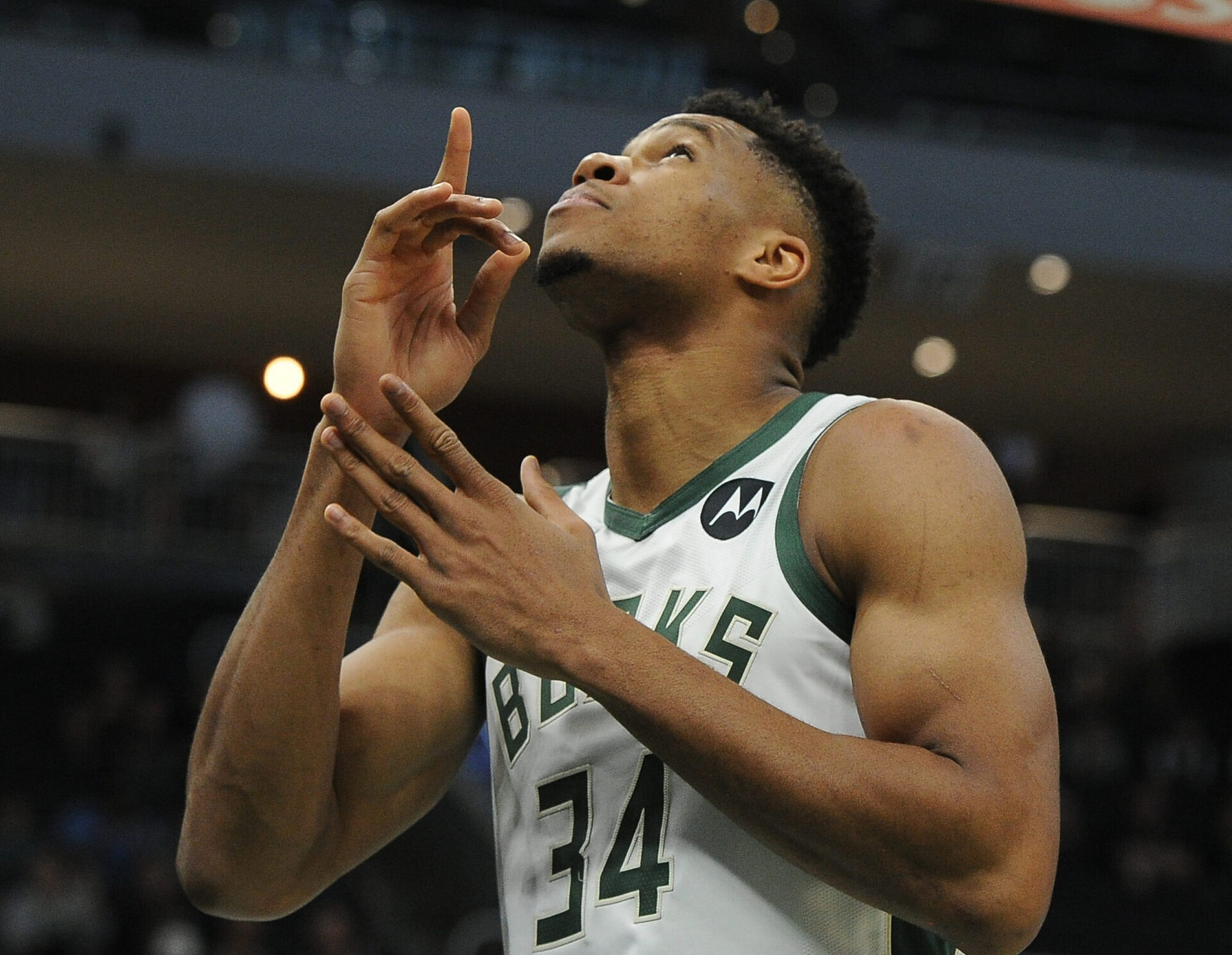 Milwaukee Bucks forward Giannis Antetokounmpo points to the sky before the start of a game