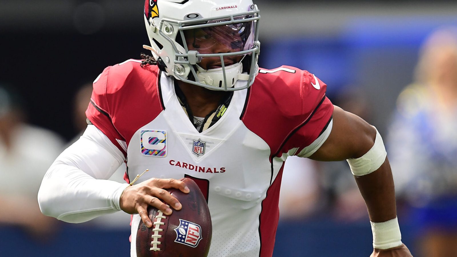 Arizona Cardinals quarterback Kyler Murray rolls out to pass