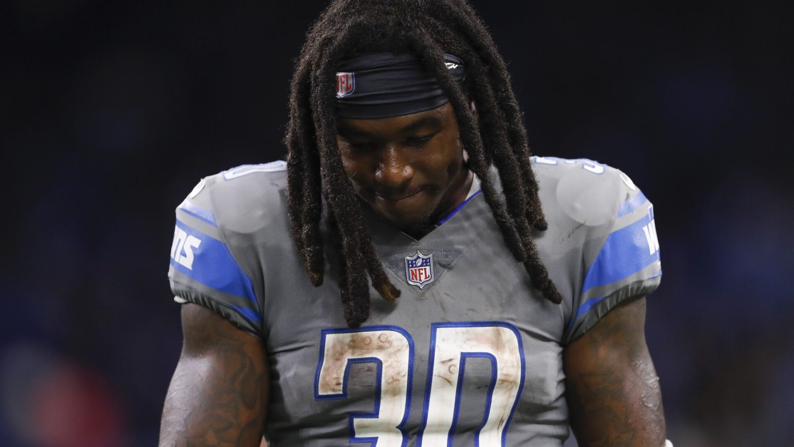 Detroit Lions running back Jamal Williams walks off the field dejected with his head down after a loss