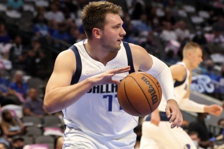 Dallas Mavericks player Luka Doncic dribbles the basketball after grabbing a rebound
