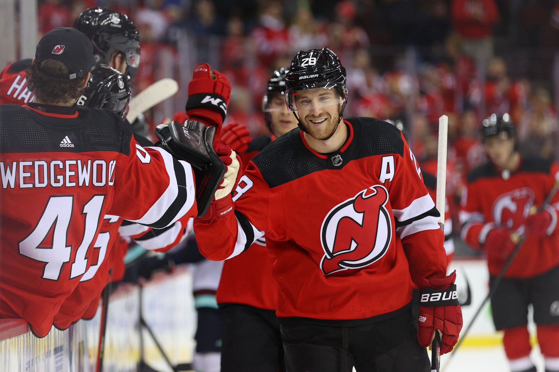 New Jersey Devils defenseman Damon Severson celebrates with teammates after scoring a goal