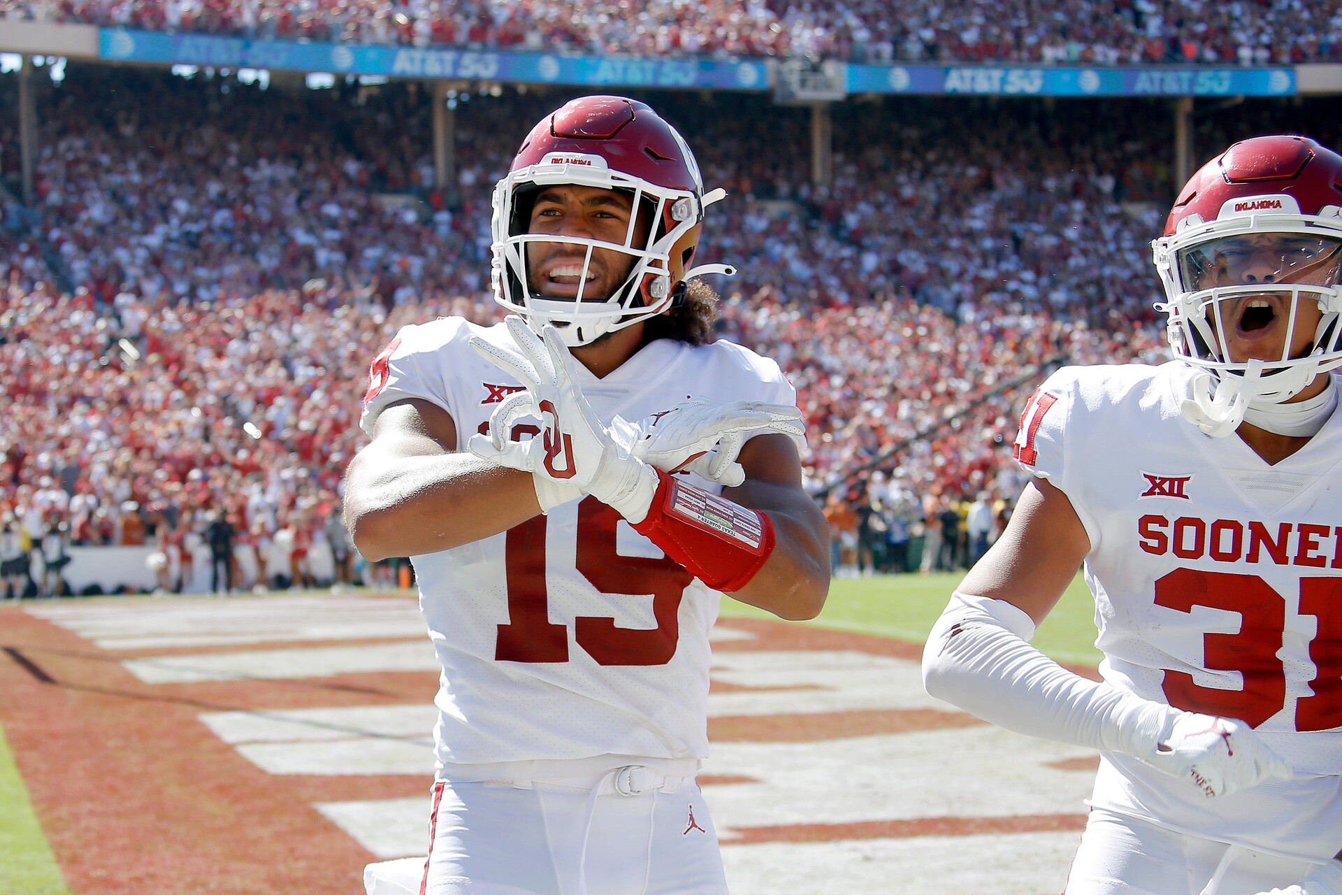 Oklahoma's Caleb Kelly on the left and Jalen Redmond on the right celebrate after a fumble recovery