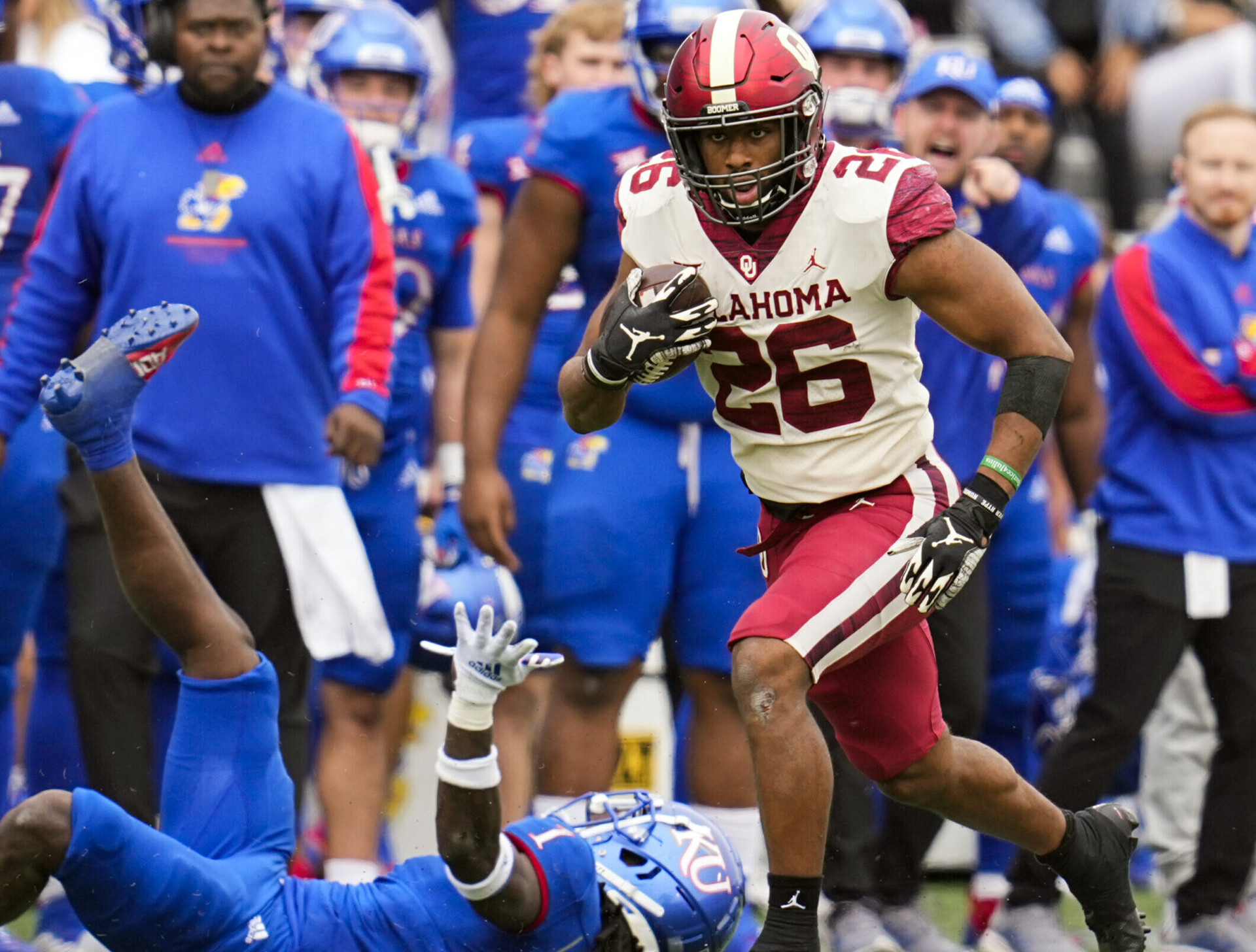 Oklahoma Sooners running back Kennedy Brooks runs against Kansas Jayhawks safety Kenny Logan Jr.