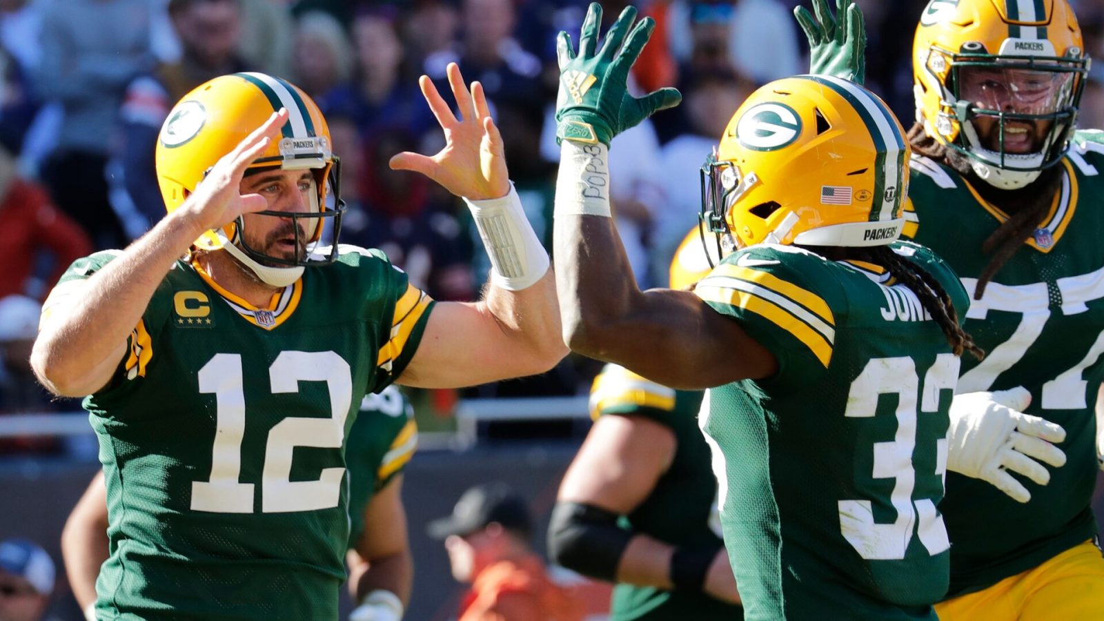 Green Packers quarterback Aaron Rodgers on the left celebrates with running back Aaron Jones after scoring a touchdown