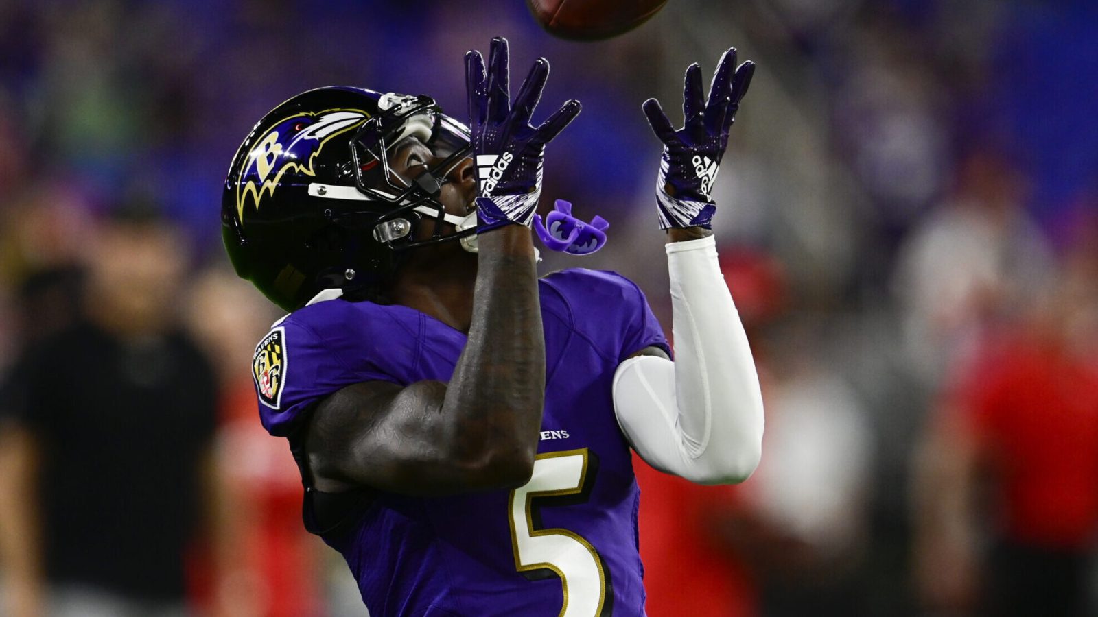 Baltimore Ravens wide receiver Marquise Brown raises his hands to catch a football