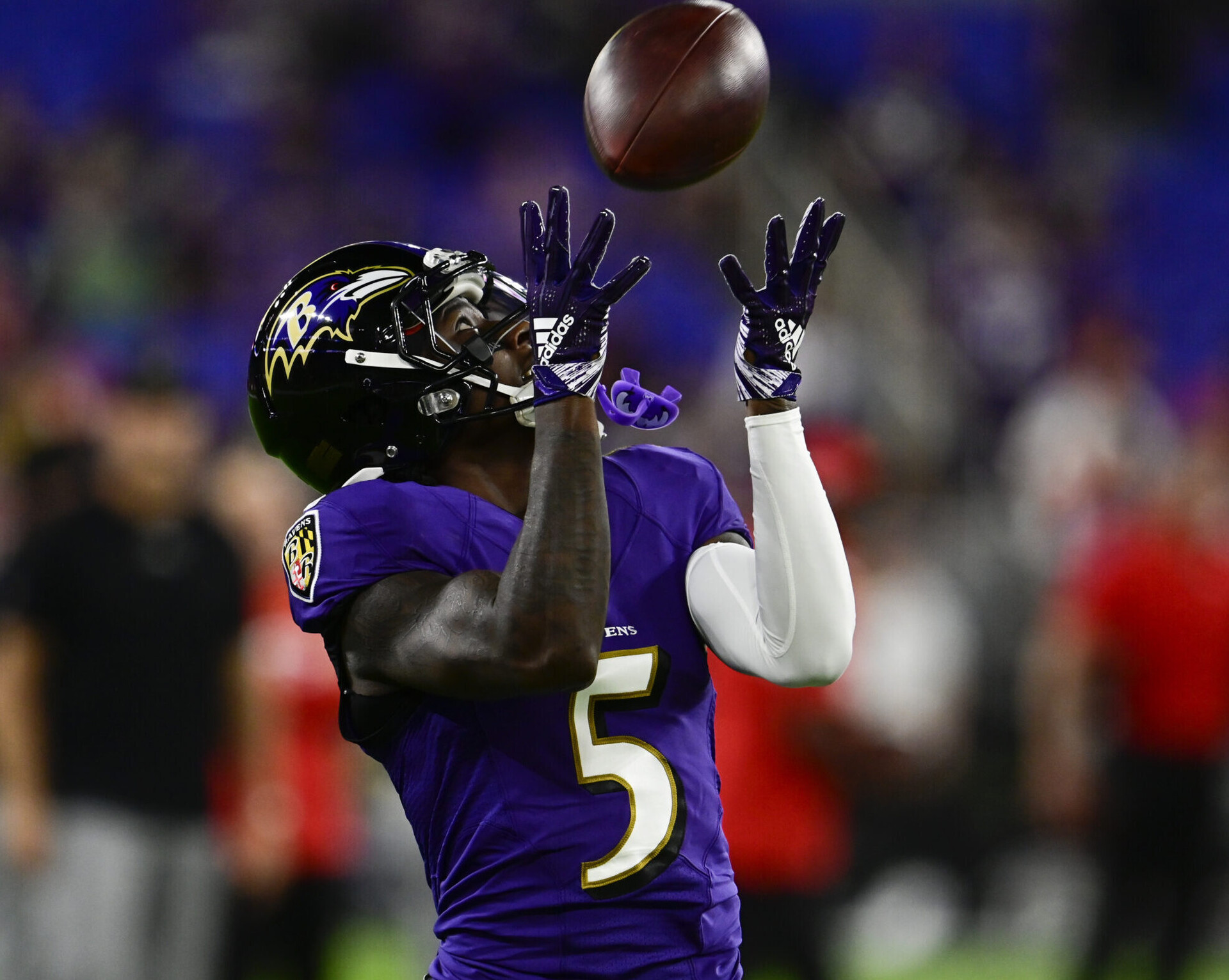 Baltimore Ravens wide receiver Marquise Brown raises his hands to catch a football