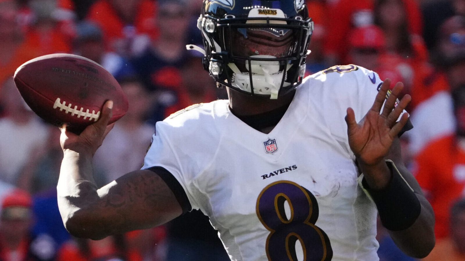 Baltimore Ravens quarterback Lamar Jackson winds up to throw a pass in a game against the Denver Broncos