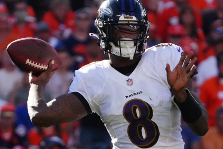 Baltimore Ravens quarterback Lamar Jackson winds up to throw a pass in a game against the Denver Broncos