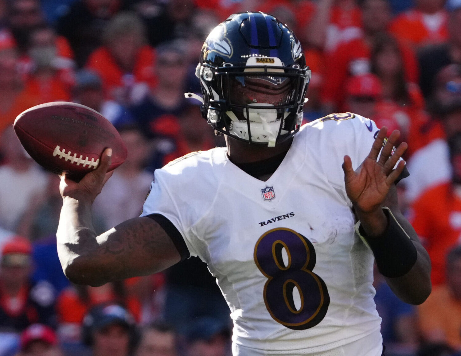 Baltimore Ravens quarterback Lamar Jackson winds up to throw a pass in a game against the Denver Broncos