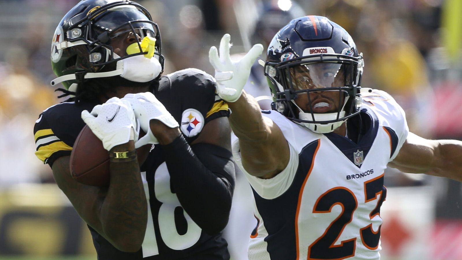 Pittsburgh Steelers wide receiver Diontae Johnson makes a catch while being defended by Denver Broncos cornerback Kyle Fuller