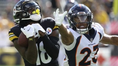 Pittsburgh Steelers wide receiver Diontae Johnson makes a catch while being defended by Denver Broncos cornerback Kyle Fuller