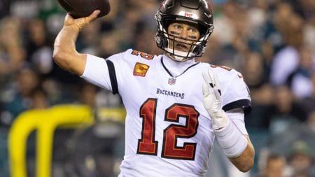 Tom Brady lifts his right arm to throw a pass