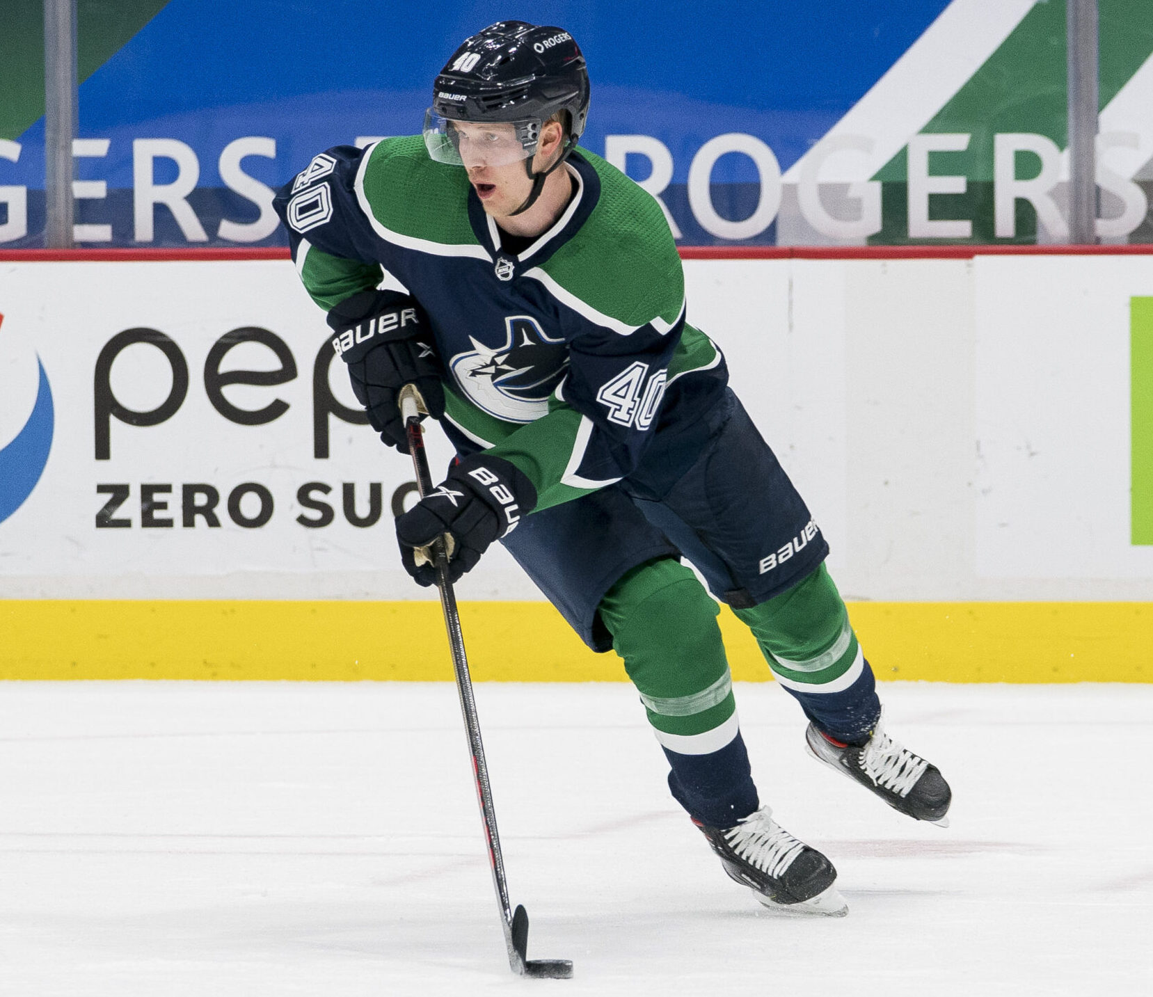 Vancouver Canucks center Elias Peterson skates with the puck during a game