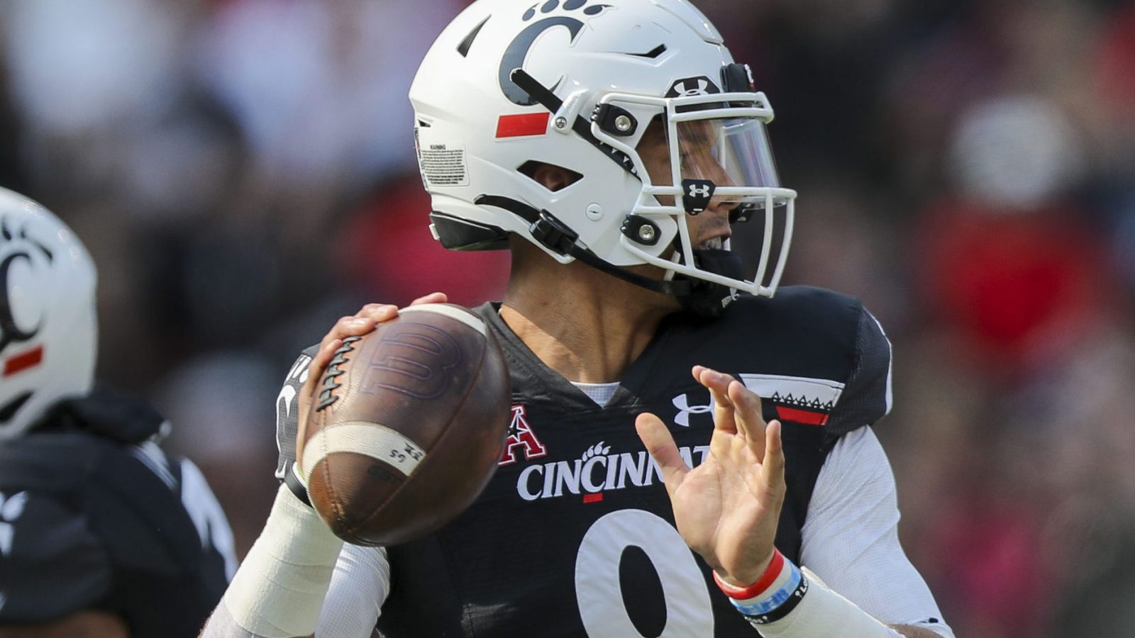 Cincinnati QB #9 Desmond Ridder looks downfield.