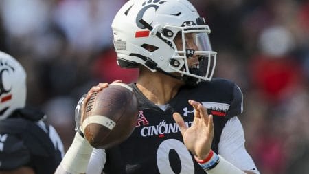 Cincinnati QB #9 Desmond Ridder looks downfield.