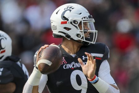 Cincinnati QB #9 Desmond Ridder looks downfield.
