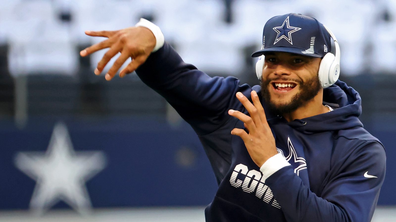 Dallas Cowboys quarterback Dak Prescott warms up before a 2021 home game.