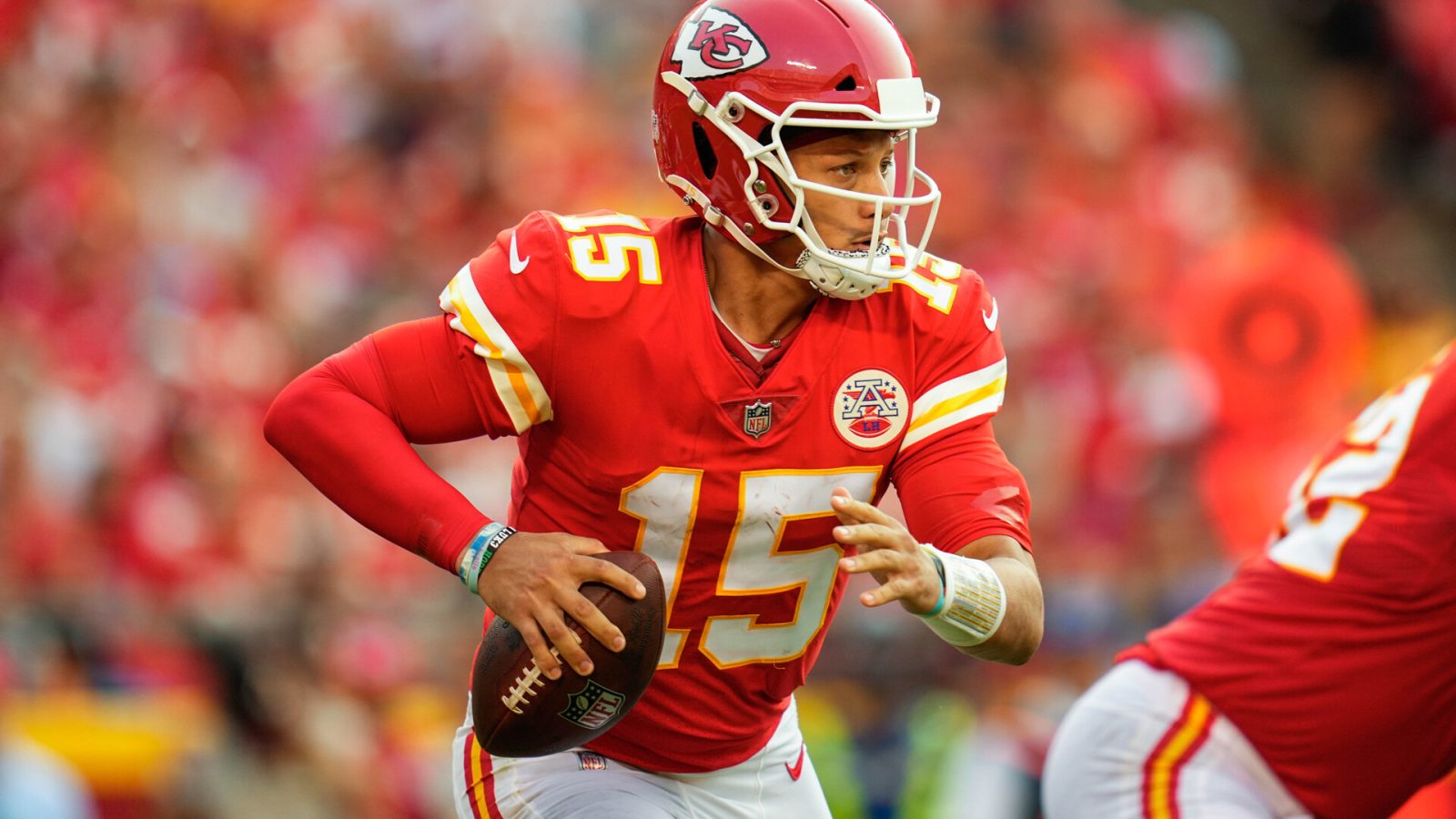 Kansas City Quarterback #15 Patrick Mahomes looks downfield for a receiver in a 2021 home game.