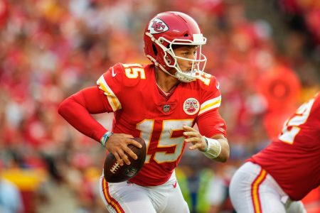 Kansas City Quarterback #15 Patrick Mahomes looks downfield for a receiver in a 2021 home game.
