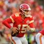 Kansas City Quarterback #15 Patrick Mahomes looks downfield for a receiver in a 2021 home game.