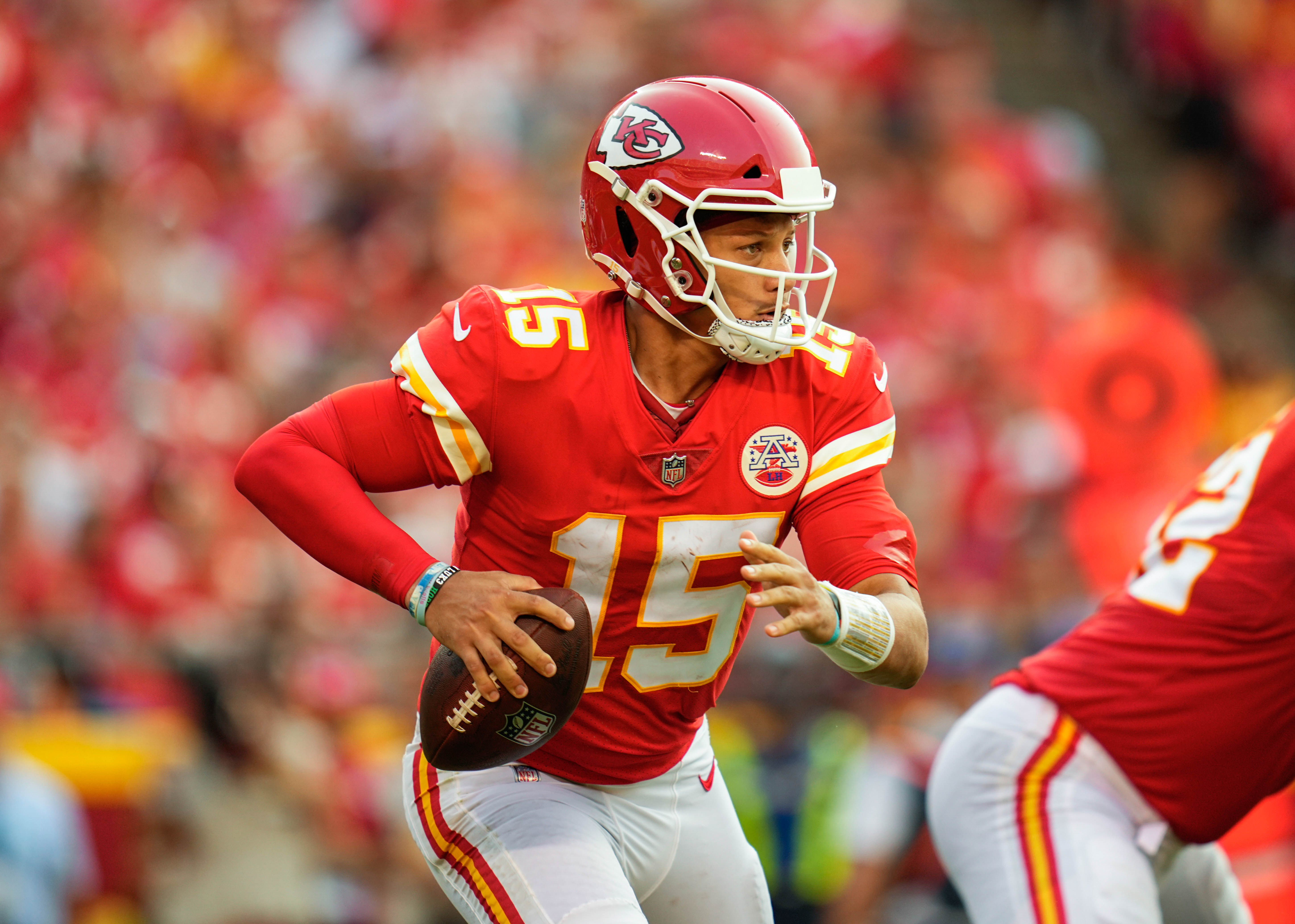 Kansas City Quarterback #15 Patrick Mahomes looks downfield for a receiver in a 2021 home game.