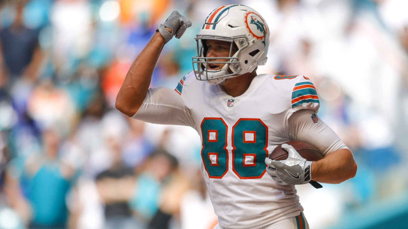 Miami Dolphins tight end #88 Mike Gesicki celebrates a play in a 2021 home game.