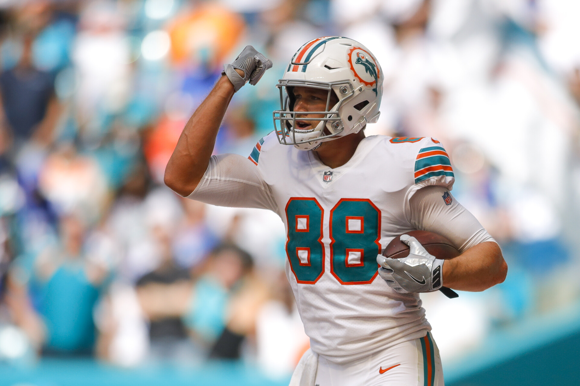 Miami Dolphins tight end #88 Mike Gesicki celebrates a play in a 2021 home game.