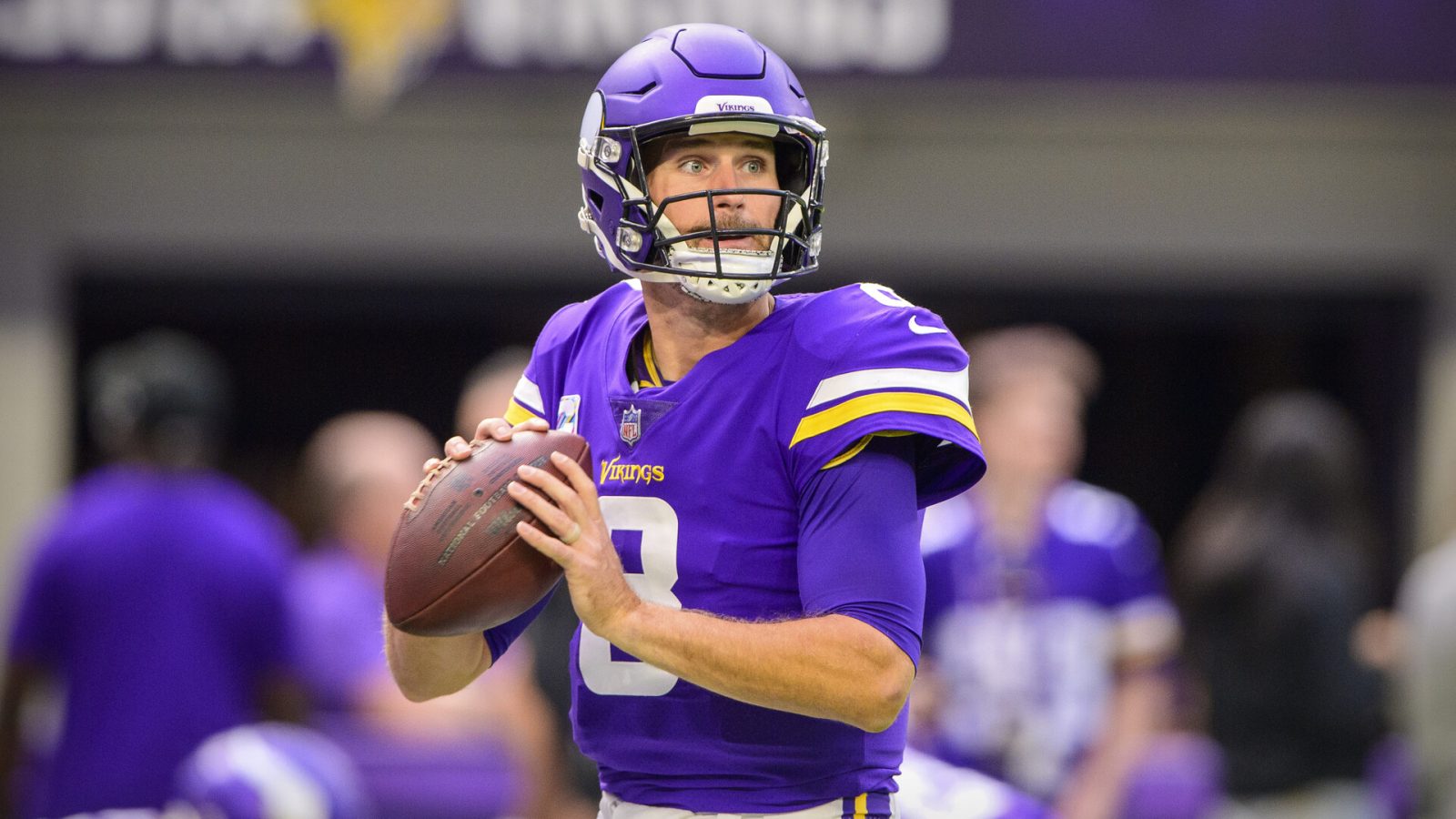 Minnesota Vikings quarterback #8 Kirk Cousins looks for an open receiver in a 2021 home game.