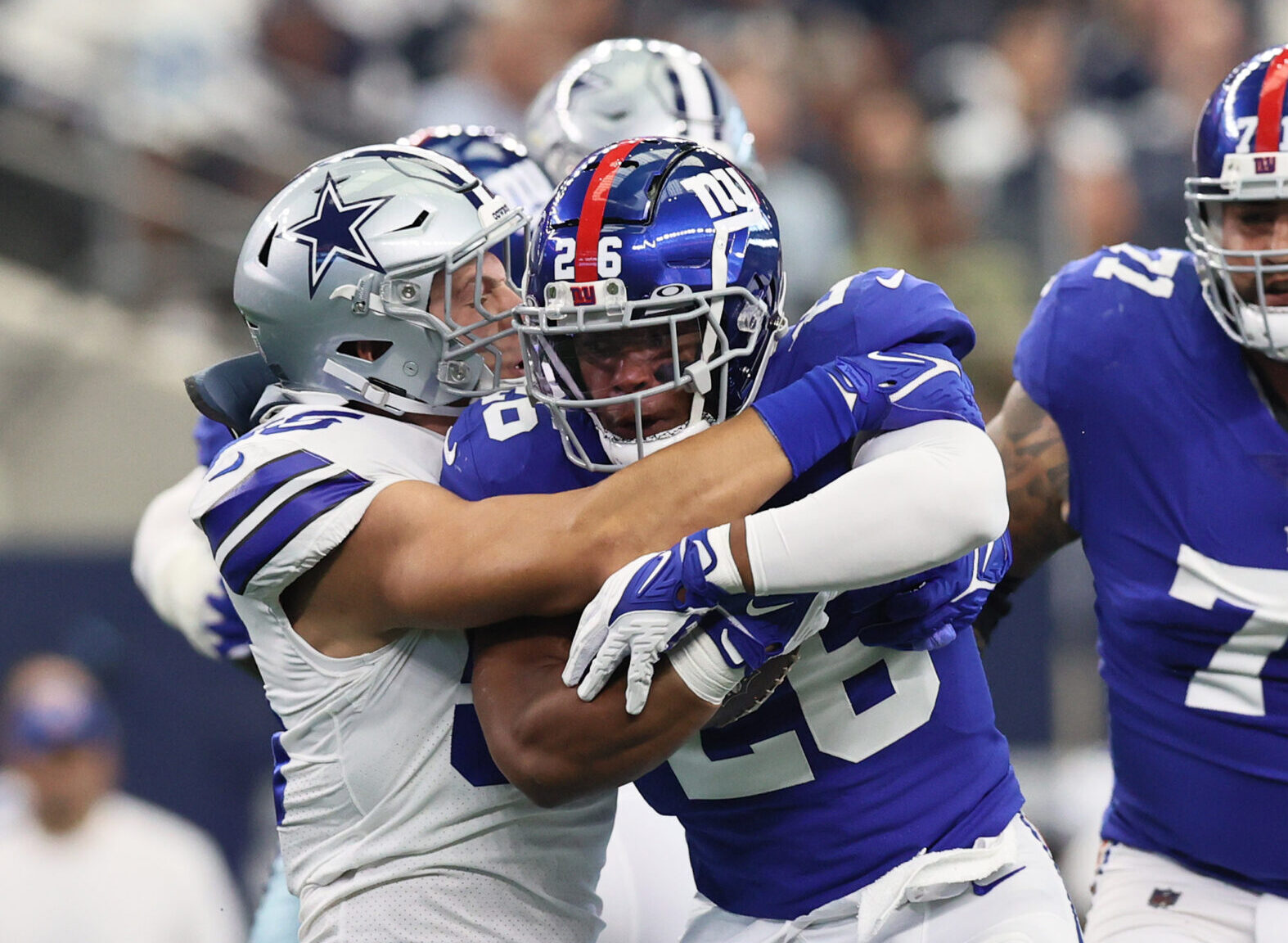 Giants running back Saquon Barkley runs through tackles against Dallas.