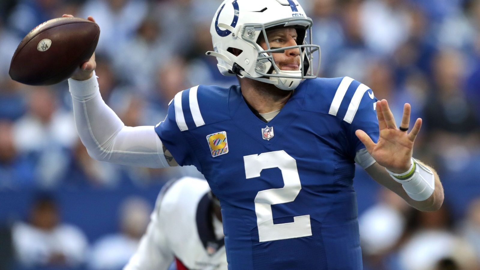 Indianapolis Colts quarterback #2 Carson Wentz throws the ball downfield in a 2021 home game.