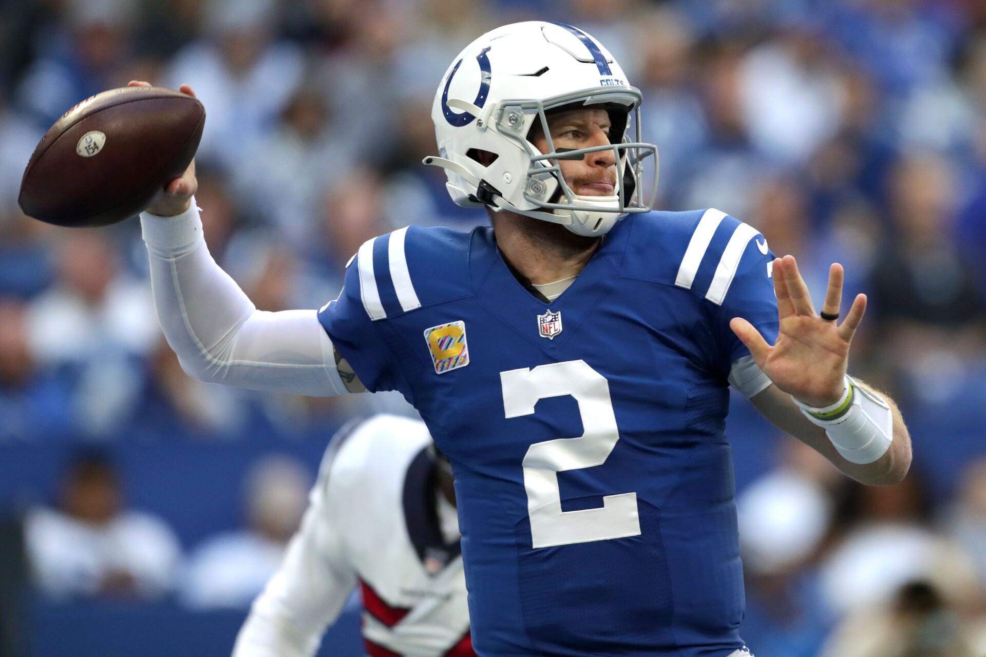Indianapolis Colts quarterback #2 Carson Wentz throws the ball downfield in a 2021 home game.