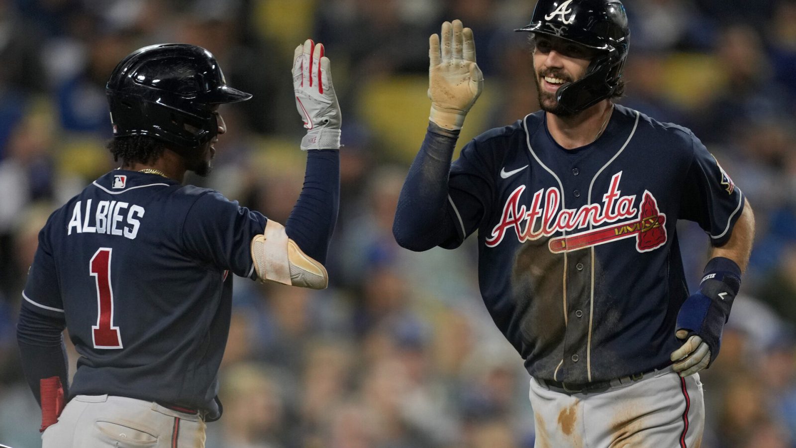 Atlanta Braves shotstop Ozzie Albies (left) greets teammate and shortstop Dansby Swanson with a high-five after Swanson hit a home run