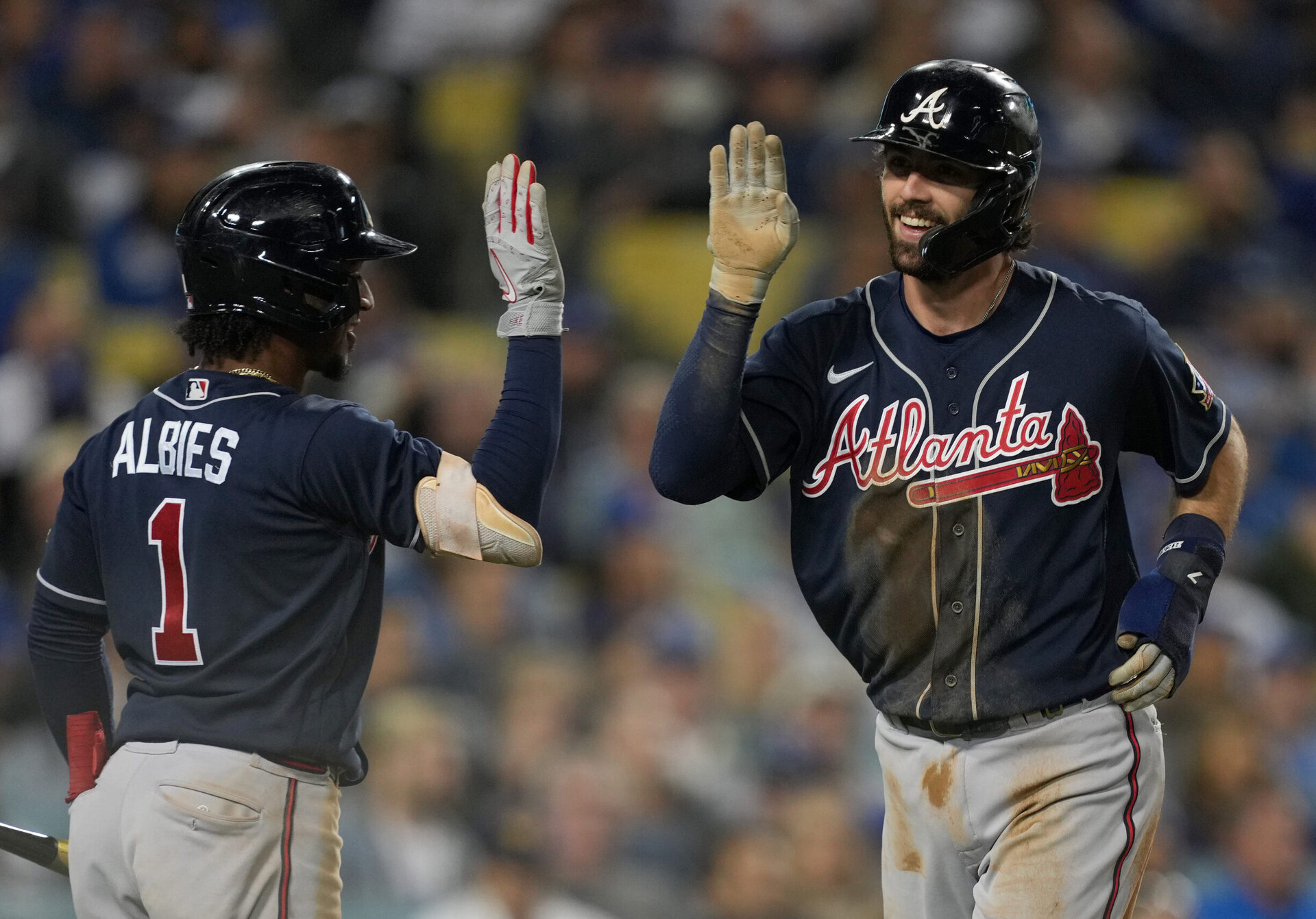 Atlanta Braves shotstop Ozzie Albies (left) greets teammate and shortstop Dansby Swanson with a high-five after Swanson hit a home run