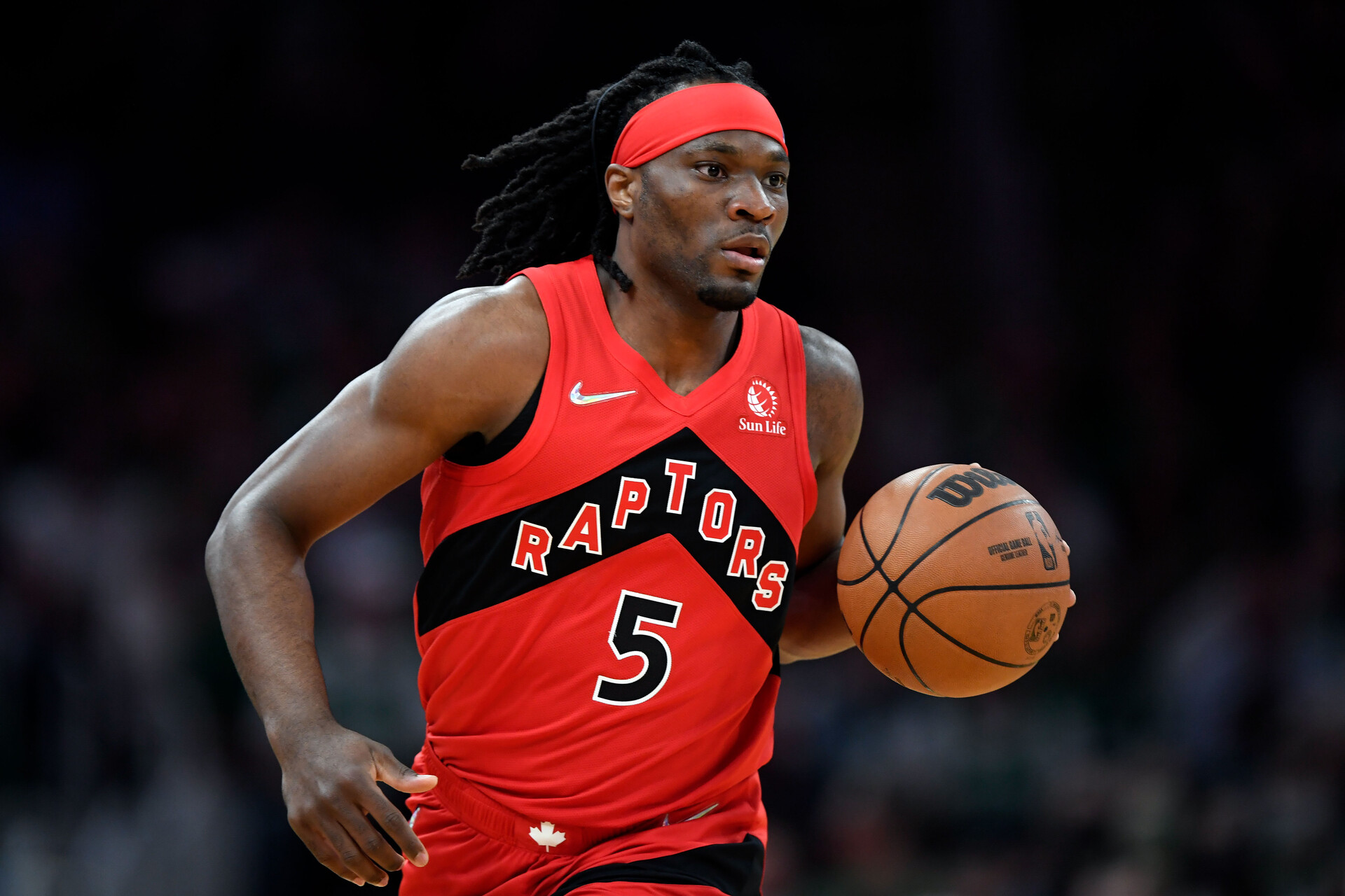 Toronto Raptors player Precious Achiuwa dribbles the ball up court during a game