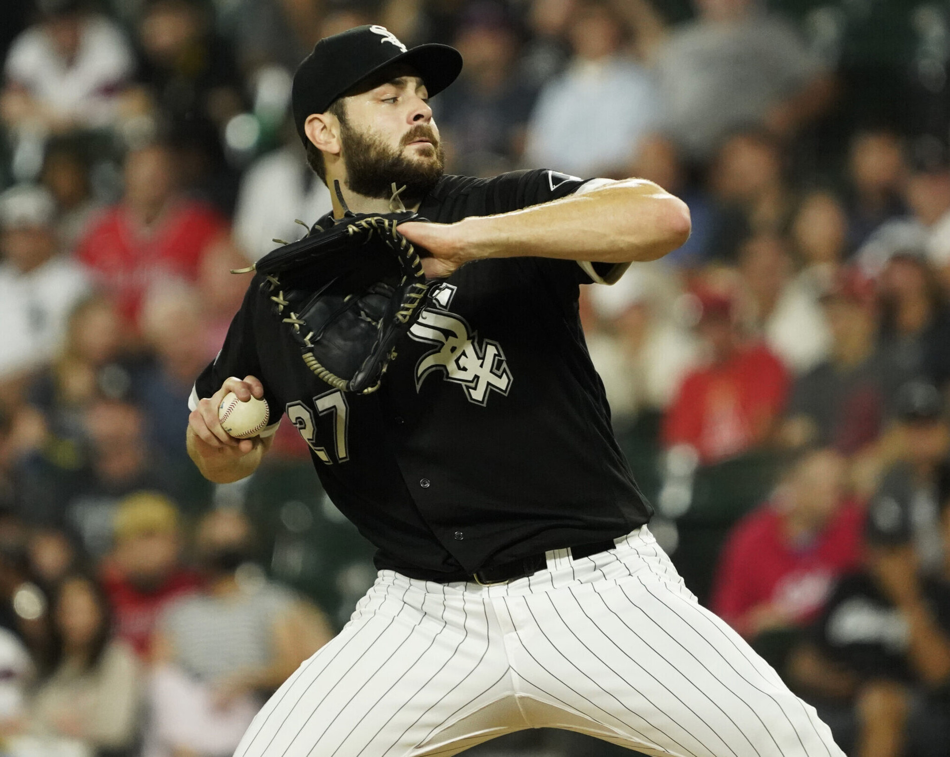 Chicago White Sox pitcher Lucas Giolito winds up to throw a pitch