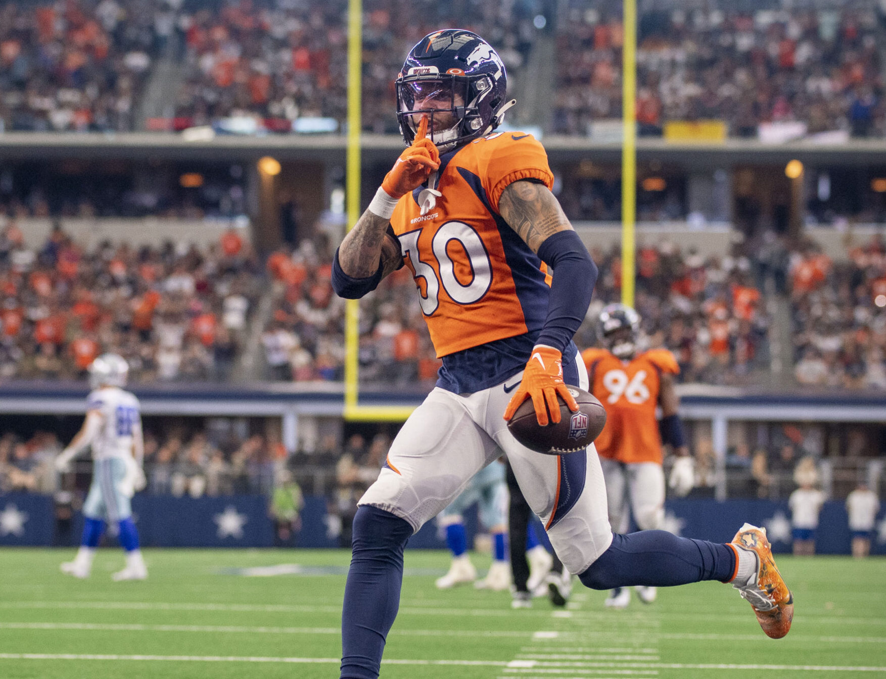 Denver Broncos safety Caden Sterns motions to the Dallas Cowboys fans after he intercepts a pass during a game