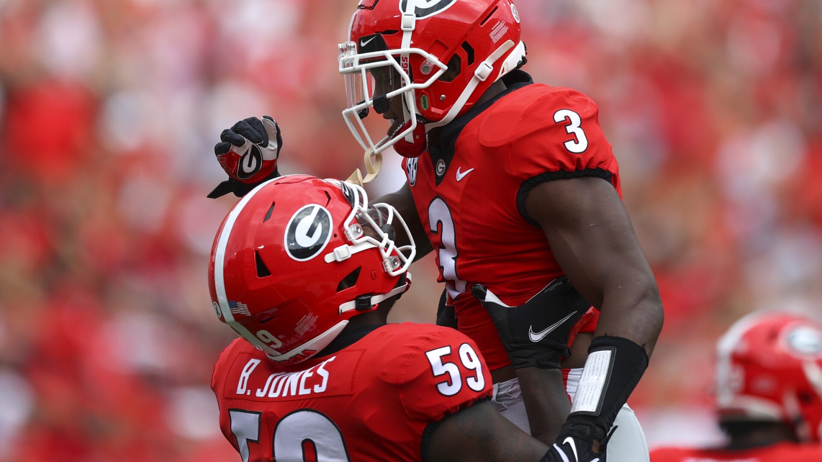 Zamir White #3 of the Georgia Bulldogs reacts with Broderick Jones #59 after a touchdown in the first half against the Arkansas Razorbacks at Sanford Stadium on October 2, 2021 in Athens, Georgia.