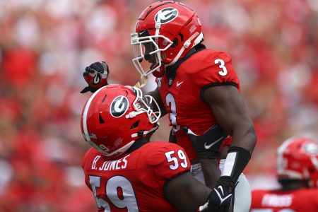 Zamir White #3 of the Georgia Bulldogs reacts with Broderick Jones #59 after a touchdown in the first half against the Arkansas Razorbacks at Sanford Stadium on October 2, 2021 in Athens, Georgia.